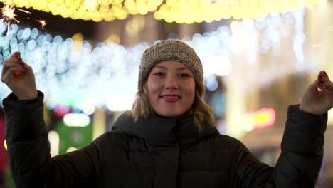 woman with sparklers on a city night