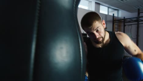 a young boxer practices punches on a punching bag 9