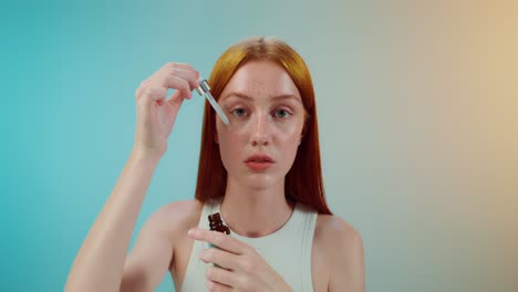 woman applying face serum
