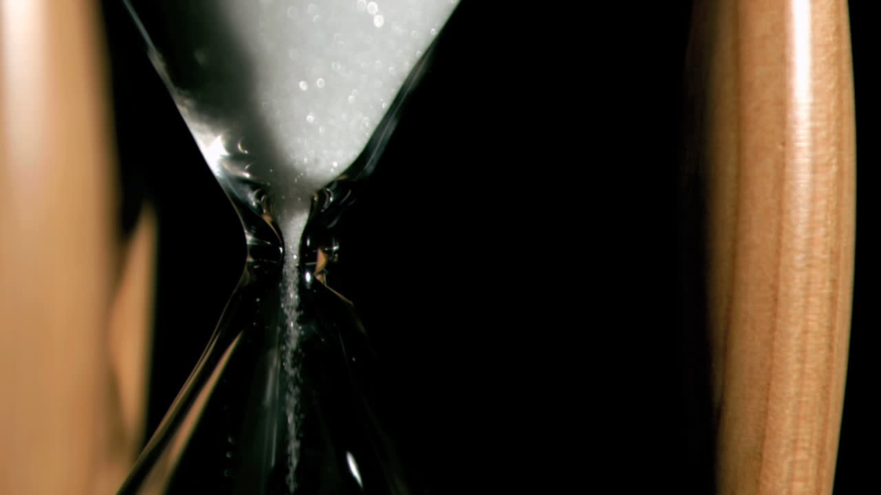Sand falling in super slow motion from a hourglass