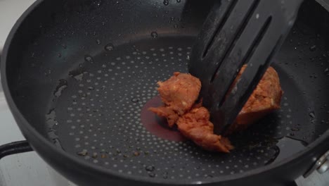 raw longaniza being cooked on a pan