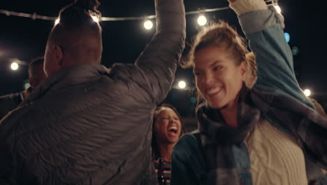 young-group-of-multiracial-friends-having-fun-dancing-playfully-together-enjoying-rooftop-party-at-night-laughing-celebrating-friendship