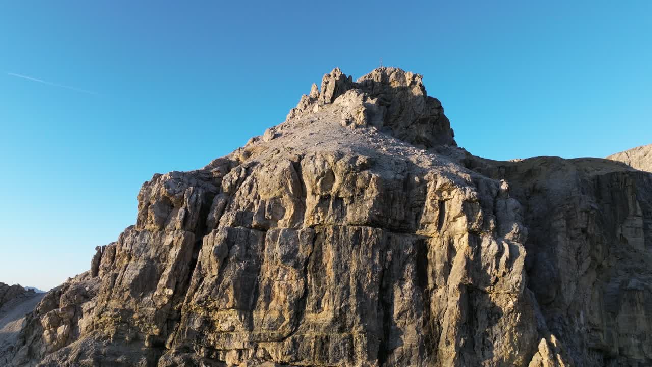 Aerial journey across the Dolomites reveals deep valleys, sheer cliffs, and alpine forests, harmoniously coming together in a mesmerizing tableau