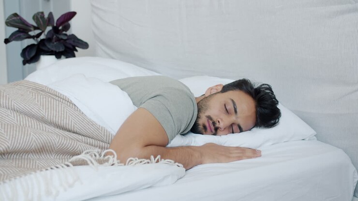Man Sleeping and Waking Up in Bed