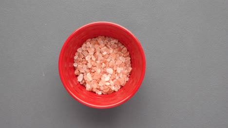 pink salt in red bowl