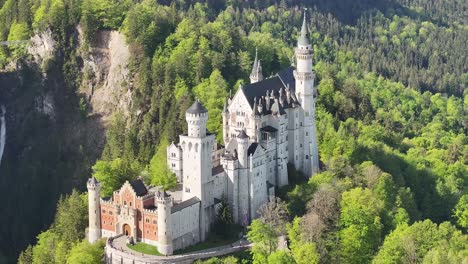 aerial view of the famous neuschwanstein castle in bavaria, germany, surrounded by lush green forest