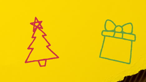 animation of hand drawing christmas decorations on yellow paper background