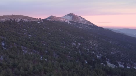 aerial side parallax view during sunset in winter with snow on mountain peaks in madrid, spain