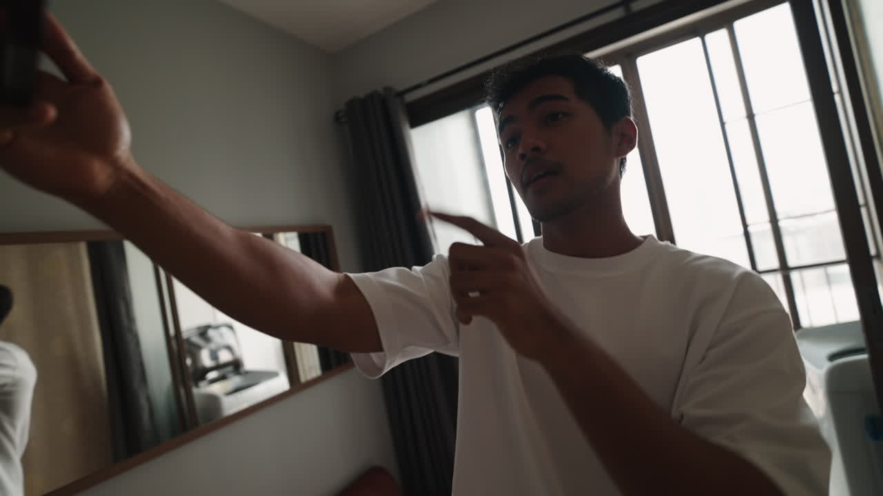A man taking a selfie in his room