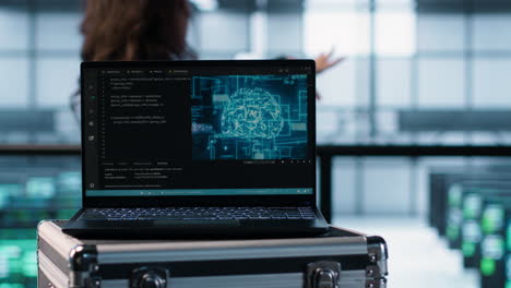 ai coding on notebook screen next to technicians inspecting servers, close up