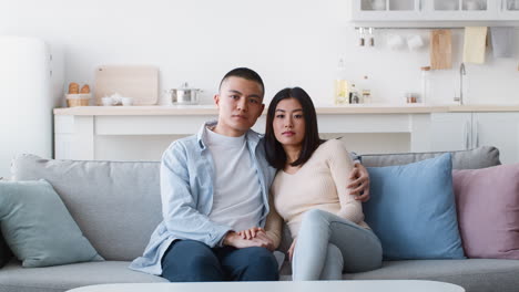 couple sitting on a sofa in a modern living room