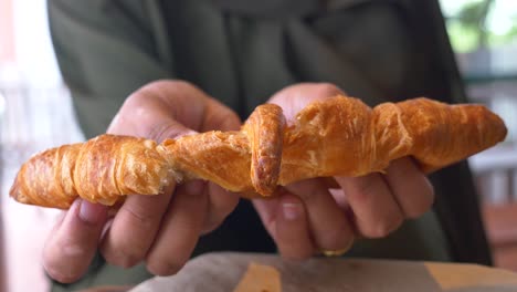 croissant in hands