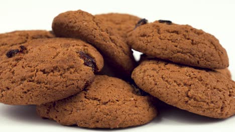 close up of soft and chewy oatmeal raisin cookies rotating on the turn table. macro.