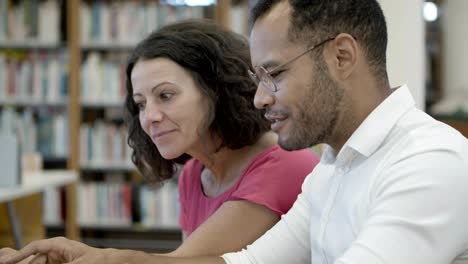 smiling people communicating at library