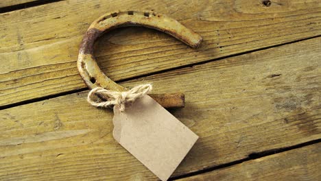 horse shoe and tag on wooden background for st patricks