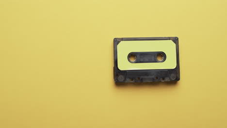 Video-of-retro-tape-with-yellow-label-with-copy-space-on-yellow-background