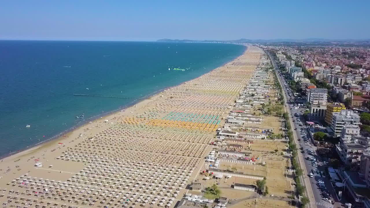 Rimini Resort Beach In Italy With A Lot Of Parasols And Sunbeds During Summertime - aerial drone shot