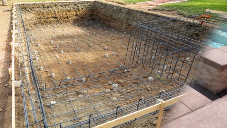 4k looping seamless cinemagraph of swimming pool construction fading to completed pool