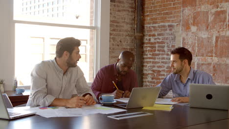 slow motion shot of creative brainstorming meeting in office