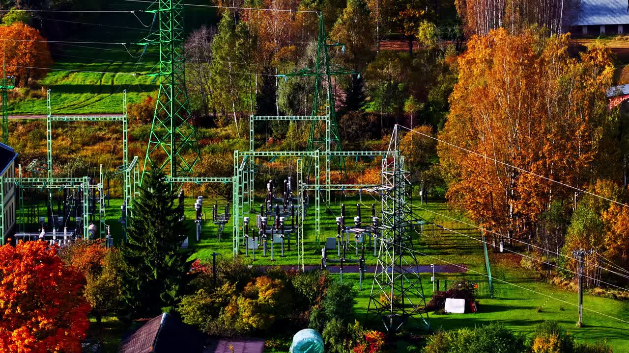Drone footage of power distribution substation amid fall colors