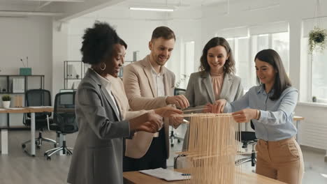 diverse business team collaborating on a project model in an office