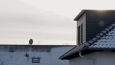 Beautiful-Cinematic-Establishing-Shot-of-Snow-Covered-Roof-in-the-Sunshine