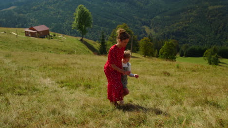 mother going up hill with daughter. woman and girl walking on mountain slope.