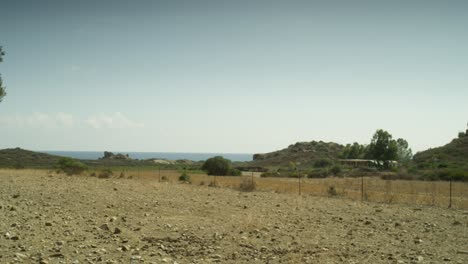 panoramic landscape view of the italian hilly countryside, in sardinia with the sea in the horizon