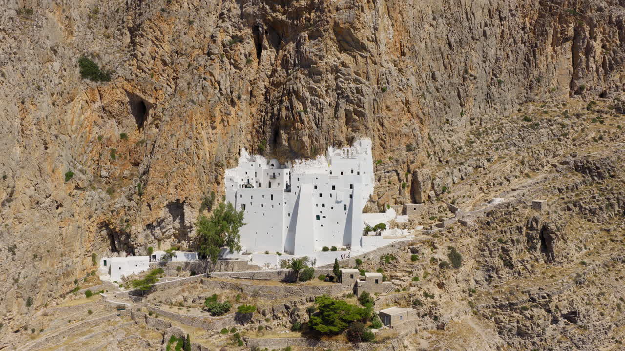 Aerial video of the iconic Chozoviotissa Monastery, built into the rock face of Amorgos island