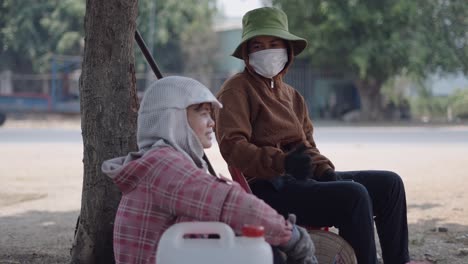 two women workers resting outdoors