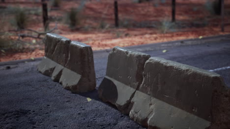 old-rusted-concrete-road-barrier-blocks