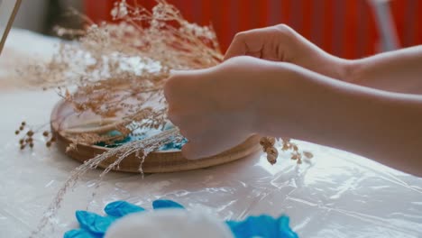 creating a resin art piece with dry flowers