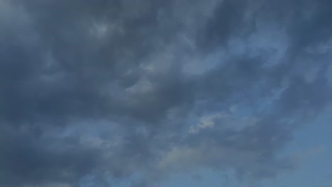 late-afternoon-thunderstorm-rain-clouds-forming-and-blending-across-the-african-horizon-time-lapse,-noise-free-4k-footage