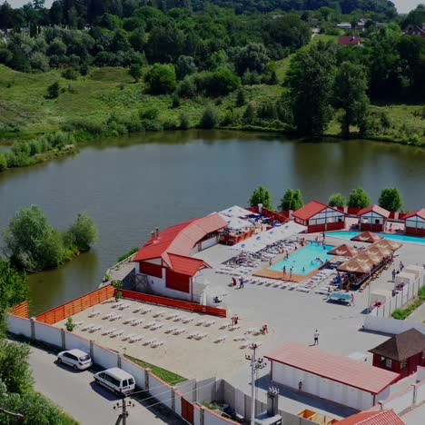 aerial drone top view on a beautiful residential area. outdoor swimming pools and green luch gardens near the river. video from above
