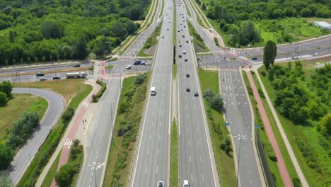 top view of freeway road. clip. highway with traffic in forest. suburban highway with cars and trucks. travel and transportation. aerial view