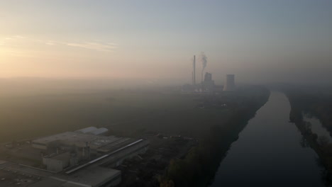 drone view of smoking factory near melnik, czech republic, air pollution during sunset