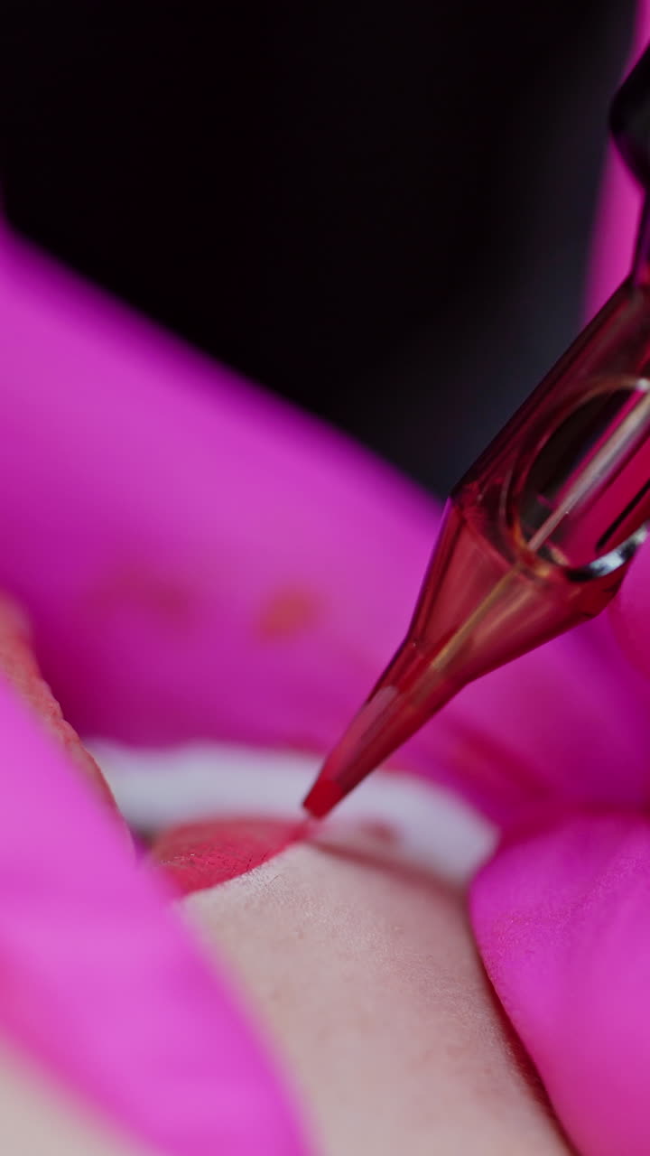 Cosmetologist applying permanent make up. Woman having permanent makeup on lips