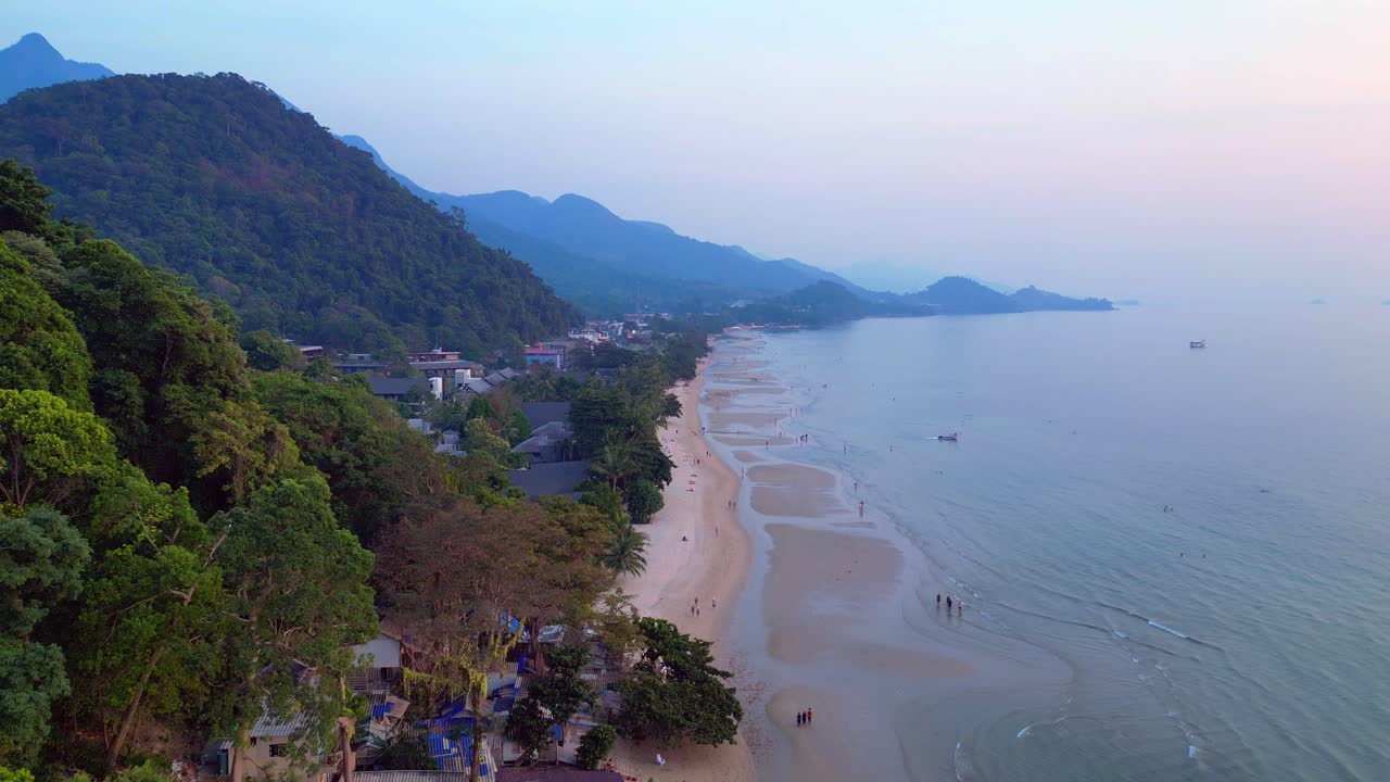 White Sand Beach at Koh Chang island, green mountain jungle along the calm turquoise sea. Lovely aerial view panorama overview drone