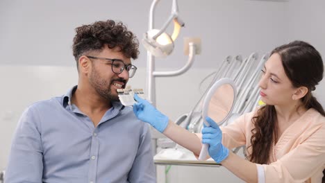 a dental professional helps assess and improve a patients smile aesthetics during a comprehensive consultation