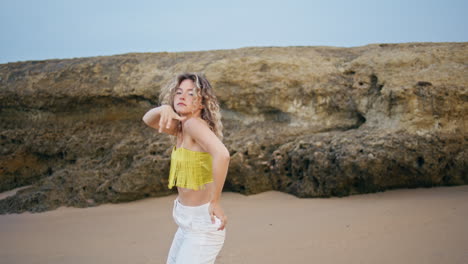 contemporary dancer performing improvisation on sand summer day. woman dancing