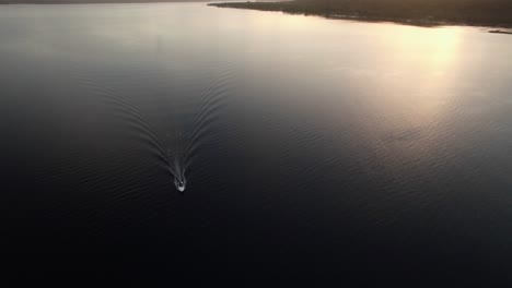 Lonely-Boat-Sailing-on-Calm-Tropical-Sea-on-Sunrise-Aerial