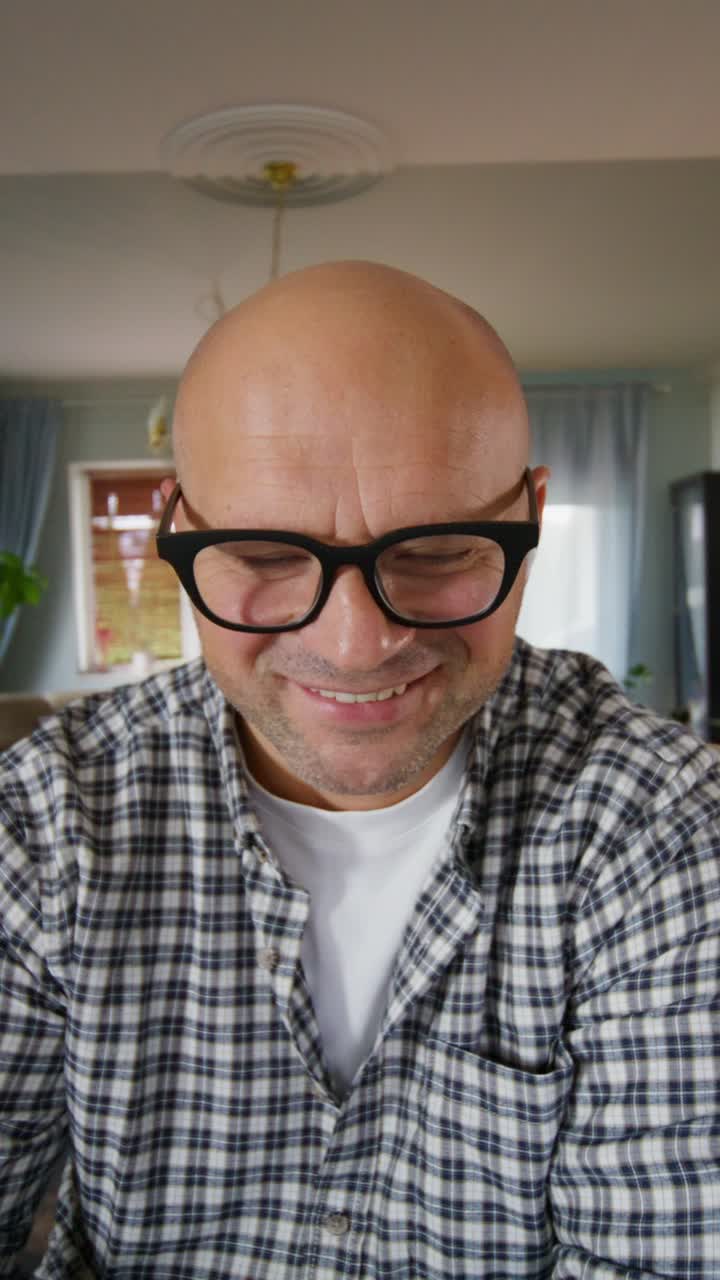 Man wearing glasses looking down
