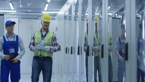 electrical engineers inspecting control panel