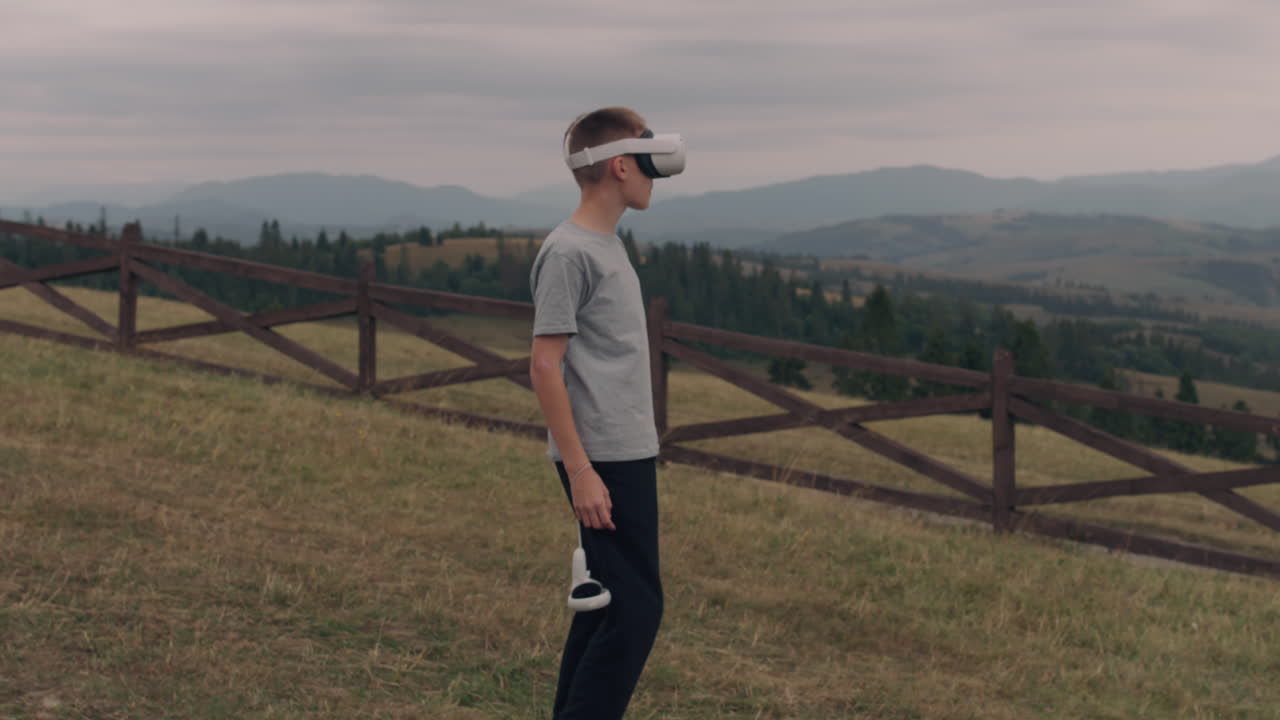 Teenager Wearing VR Headset in a Mountain Landscape