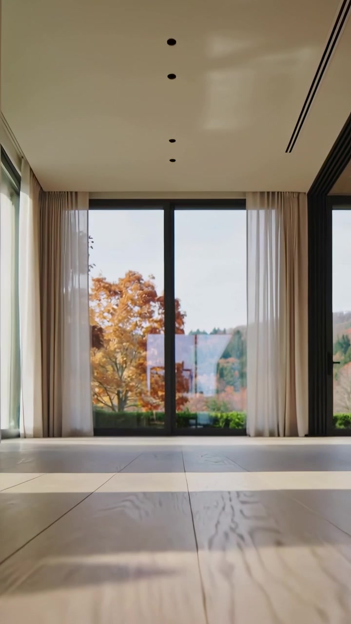 Video verticale: Telecamera bassa che scorre sul pavimento, rivelando un albero di arance attraverso le porte a vetri di casa.