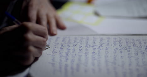 senior businessman writing on paper at table in office 22