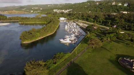 pull away drone shot of yachts at american memorial park, saipan