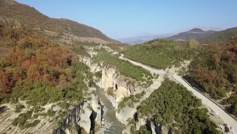 road running next to osumi canyon doing a road trip in albania europe with the summer sun shining