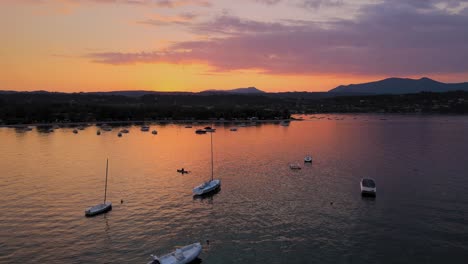 magical colorful sunset sky and mirror reflection on lago di garda, italy