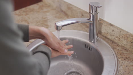 Woman-in-self-isolation-in-quarantine-during-coronavirus-pandemic-washing-he-r-hands